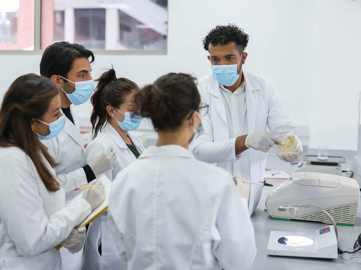 Group of lab technicians taking notes