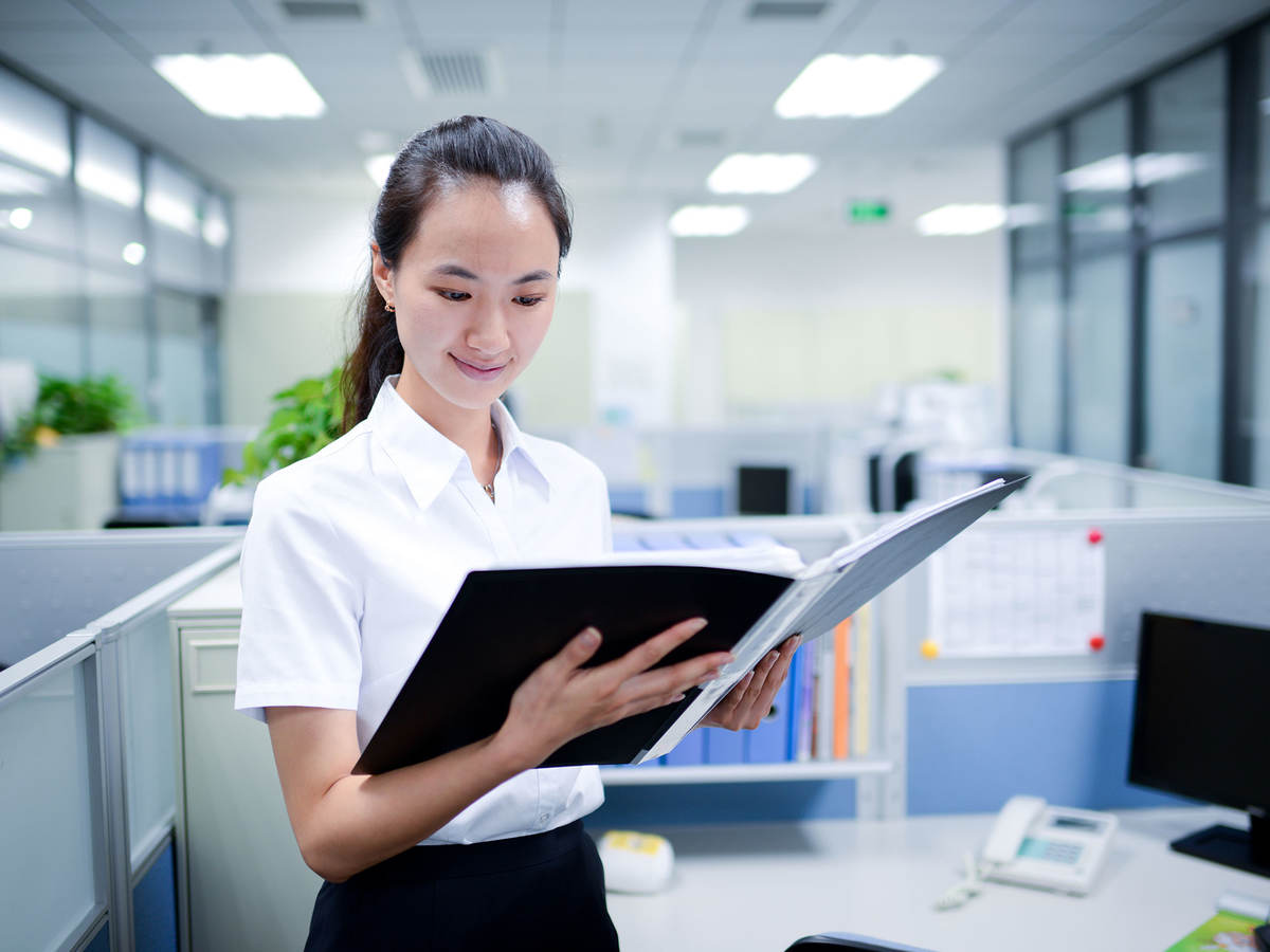 Person looking at documents in a binder