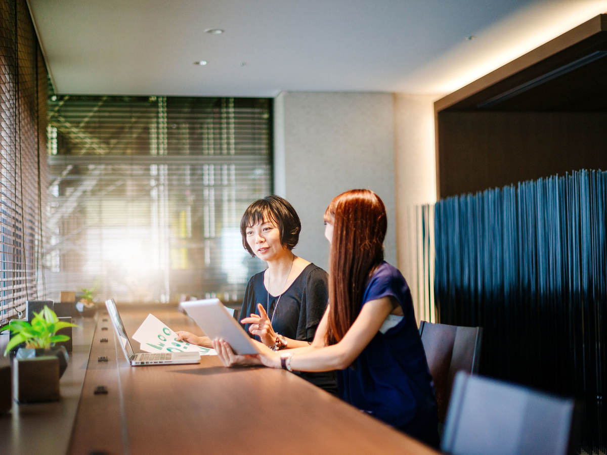 Two women comparing notes in an office