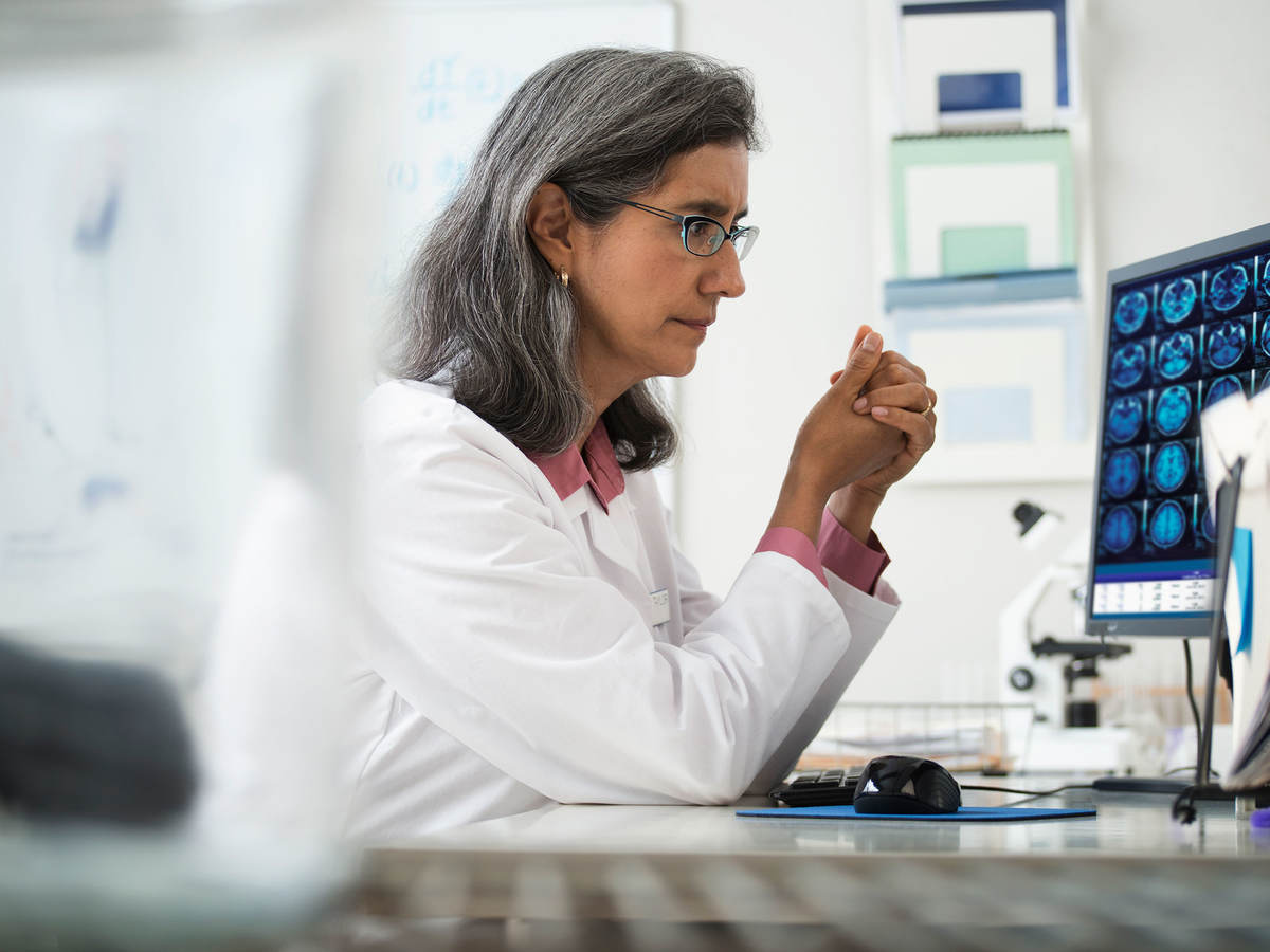 Doctor reviewing x-rays on a computer