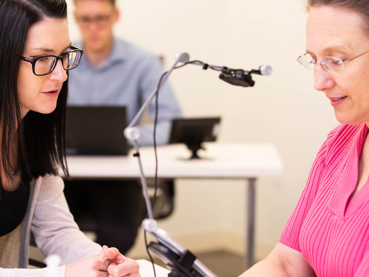 Two people talking in a testing room