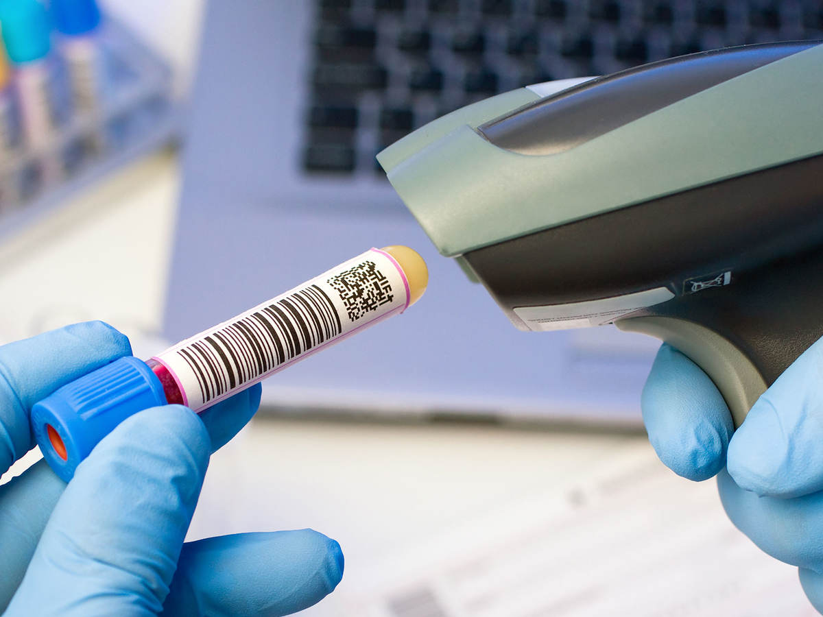 Person scanning a QR code on a test tube