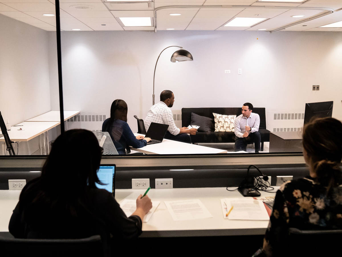 Two people observing a focus group