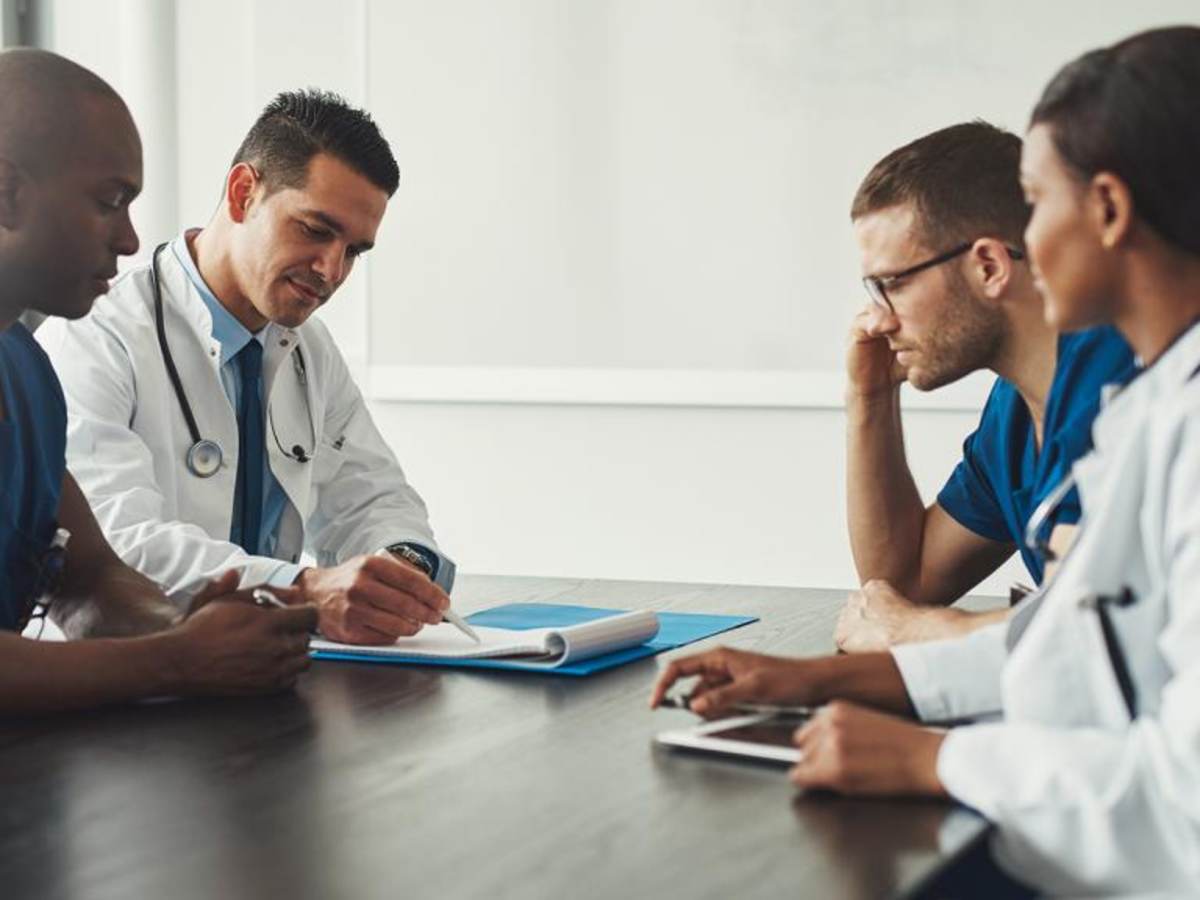 Doctors sitting at a table discussing notes