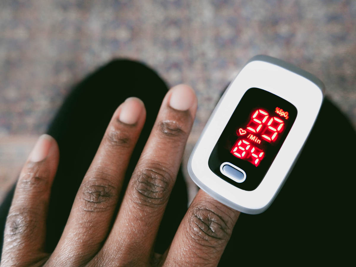 Person using Oximeter on finger