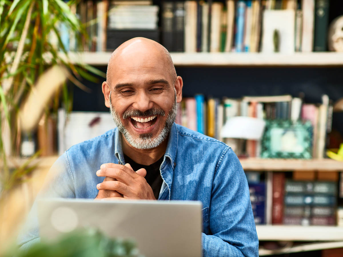 Person clasping hands and smiling