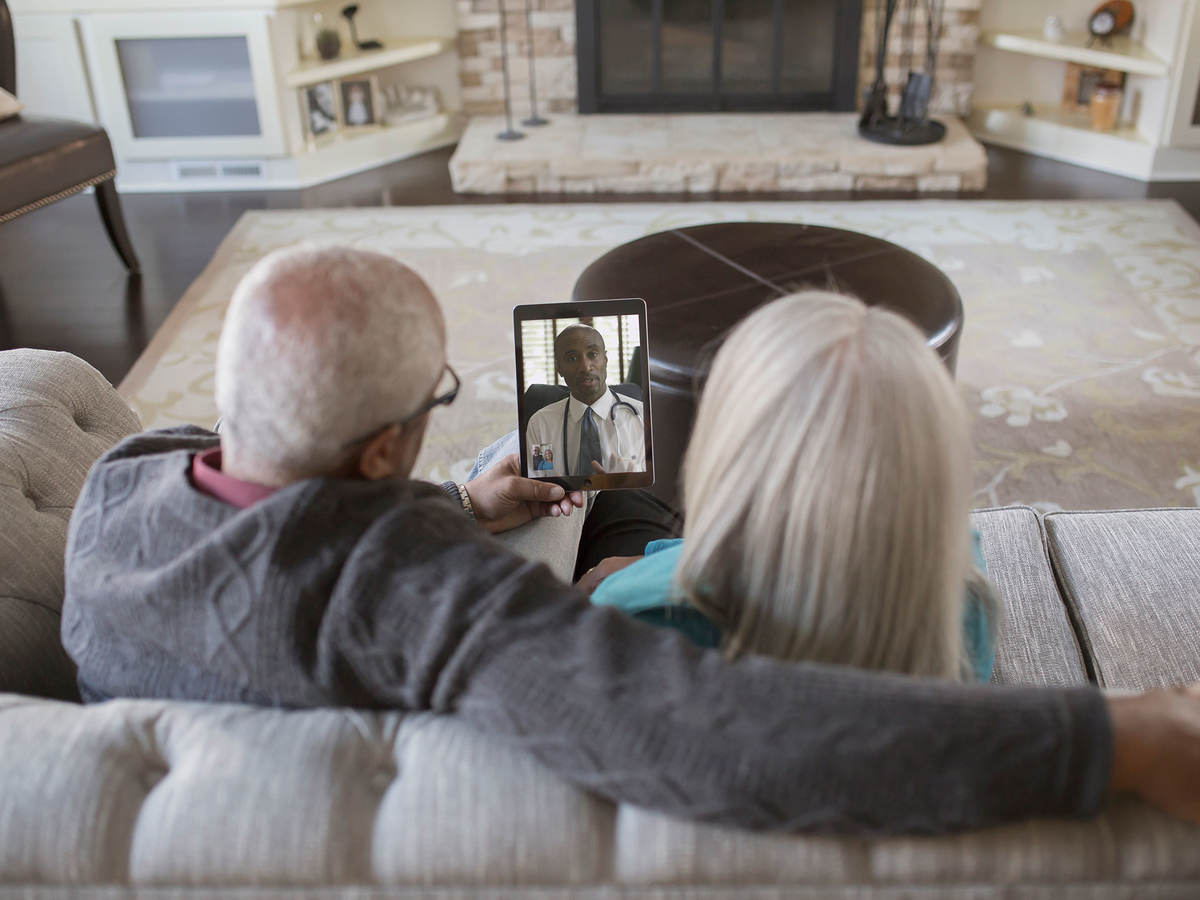 Two people having a virtual visit with their doctor