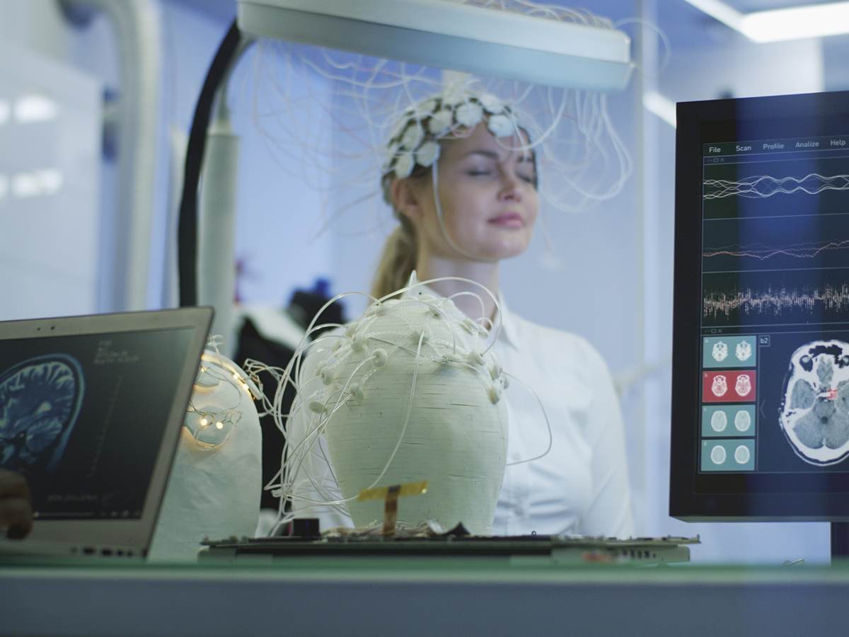 Technician operating diagnostic equipment for a patient.