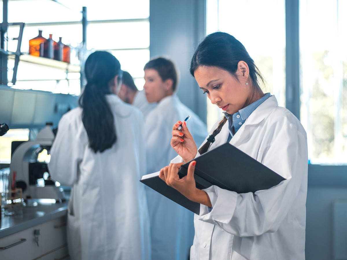 Medical doctor reviewing notes in a book