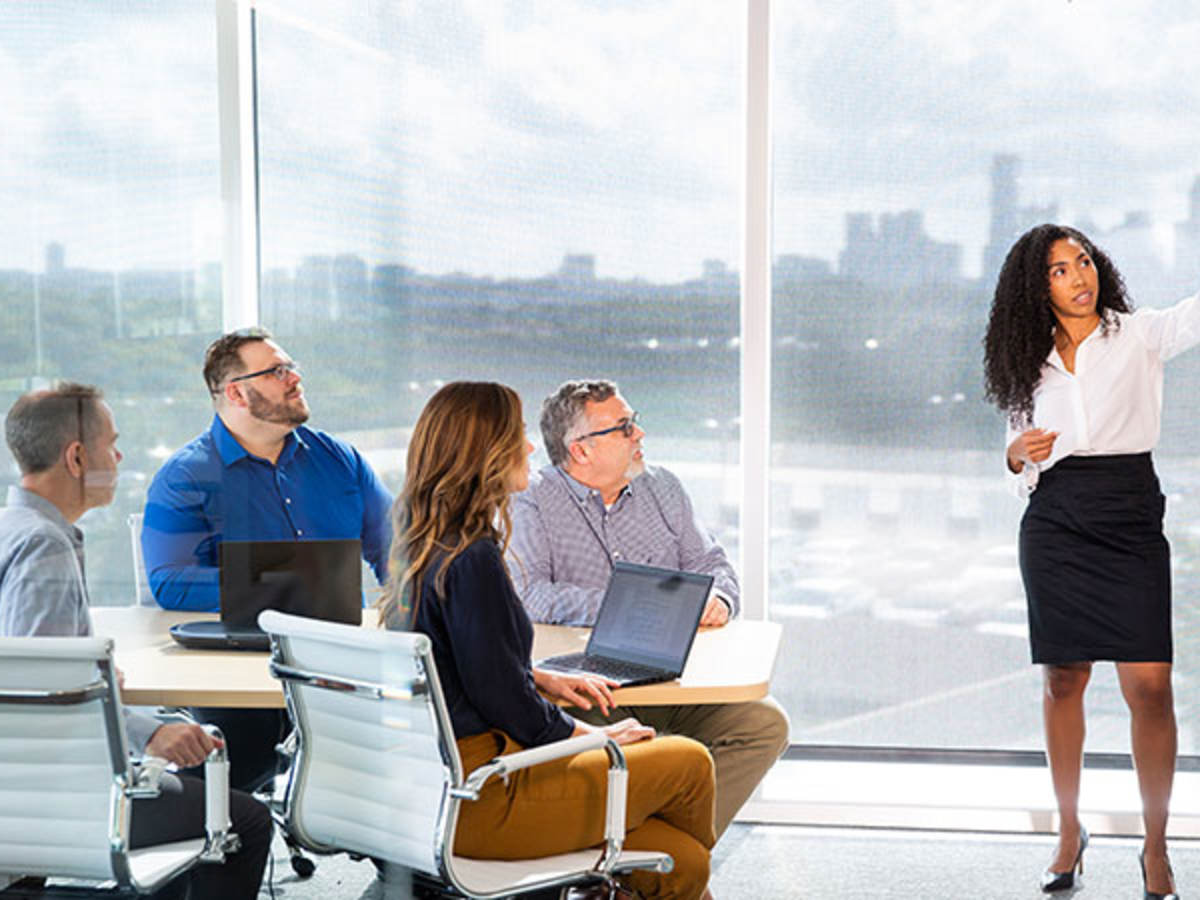 Person presenting in a conference room