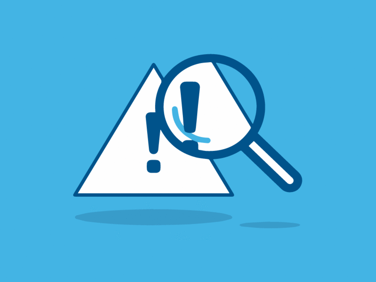 Magnifying glass looking at triangular warning icon