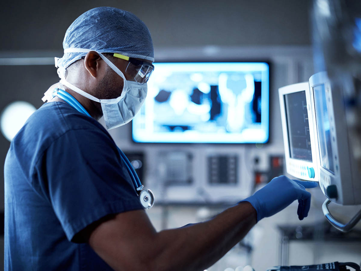 Doctor in operating room looking at a display