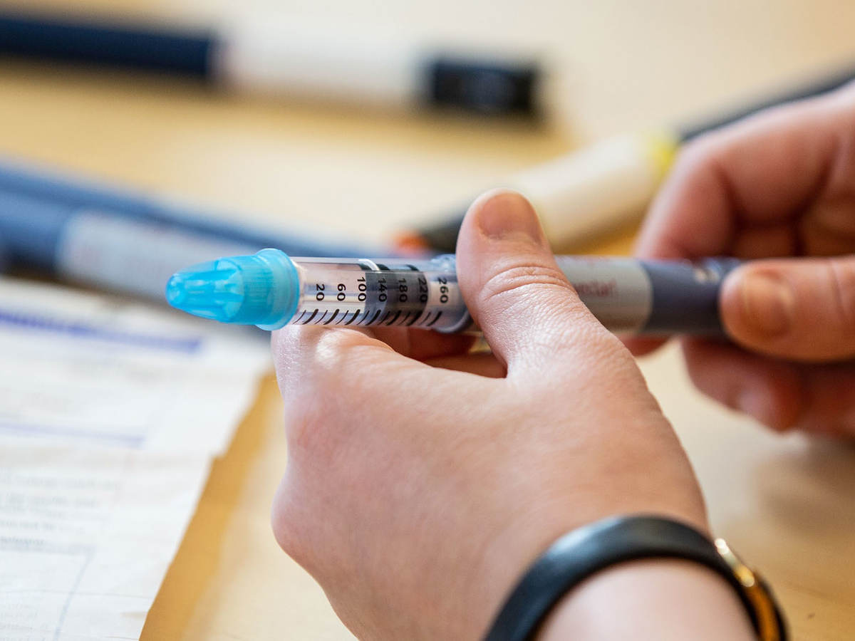 Person holding a syringe