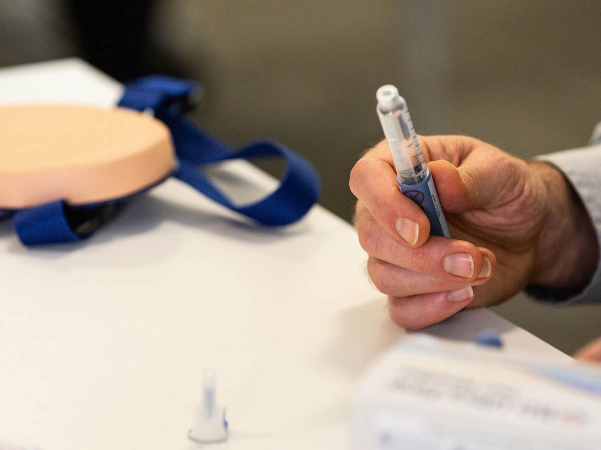 Person holding a syringe