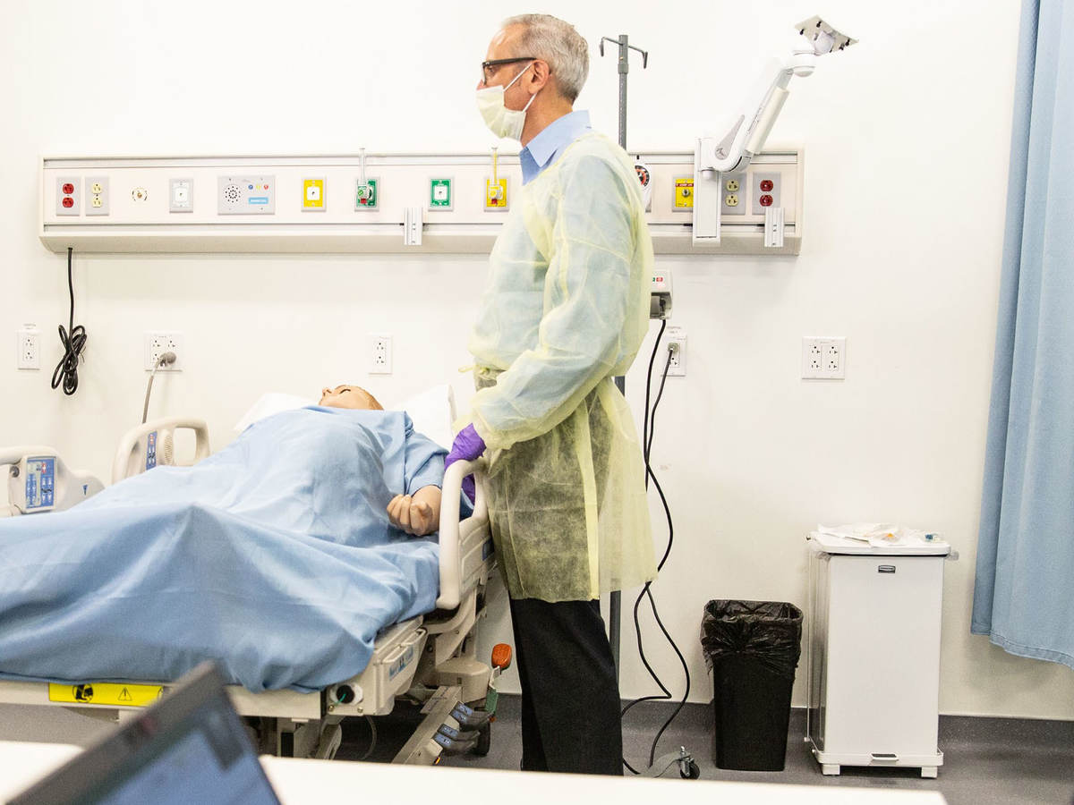 Doctor standing over patient in a hospital