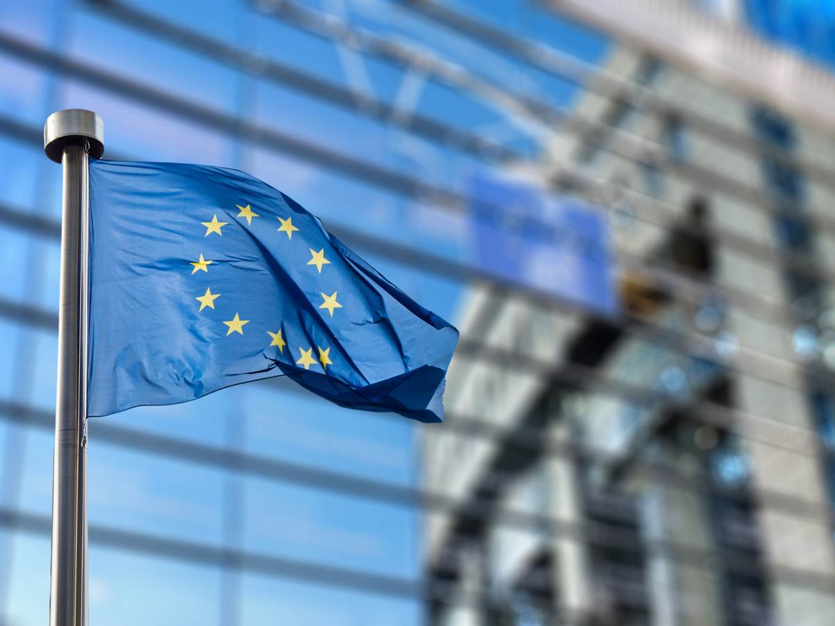 EU flag waving in front of a building