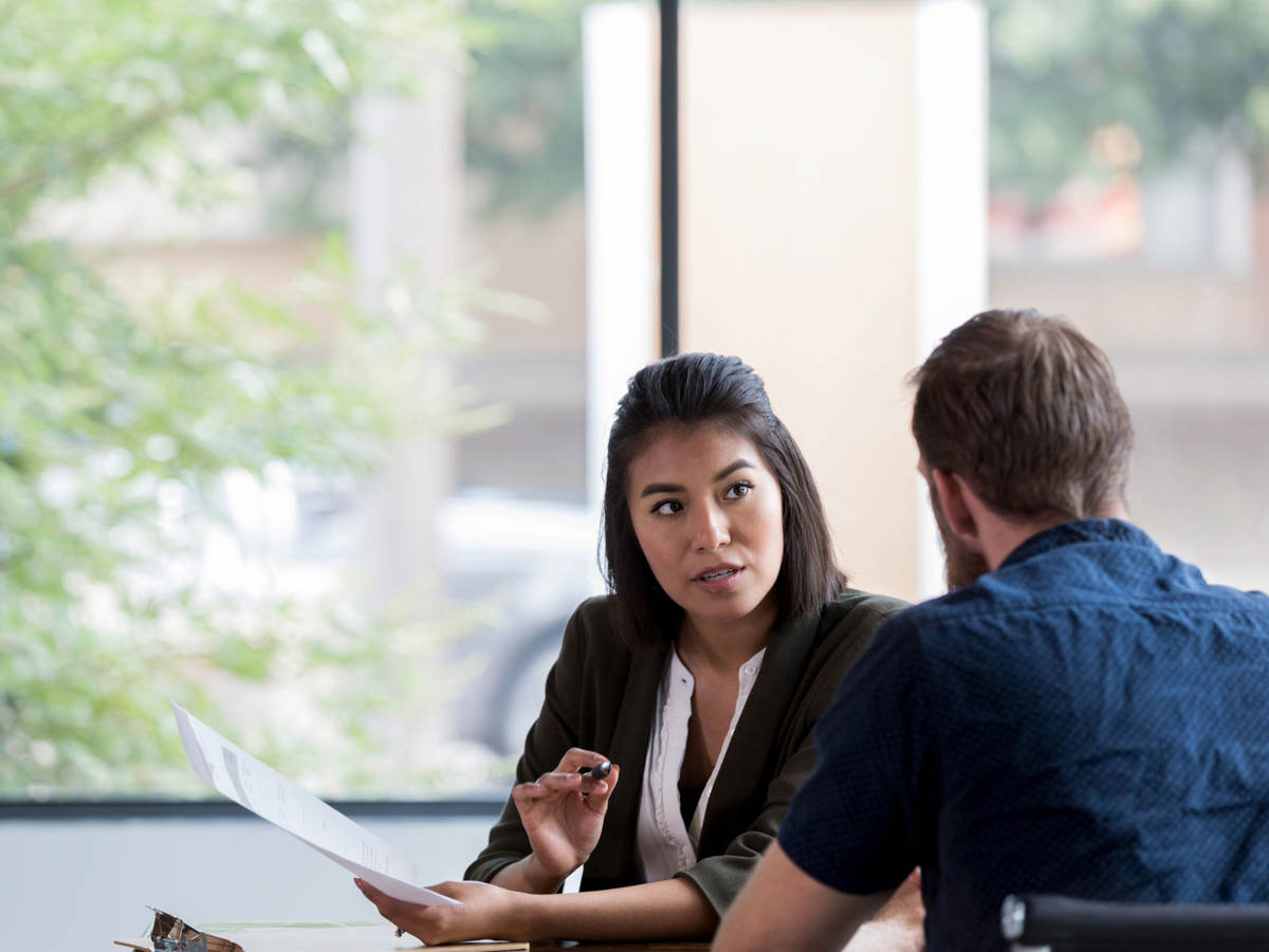 Two people discussing a document