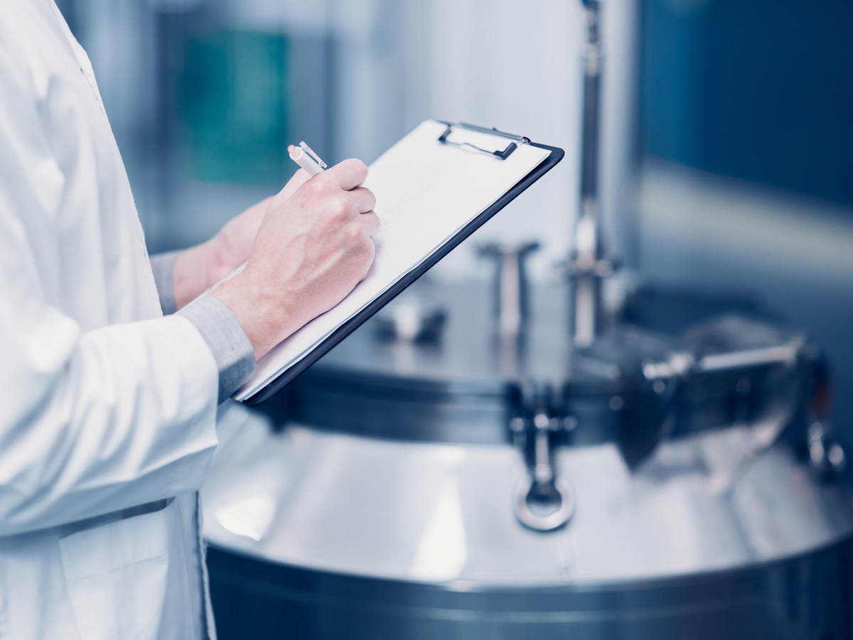 Scientist writing notes on a clipboard