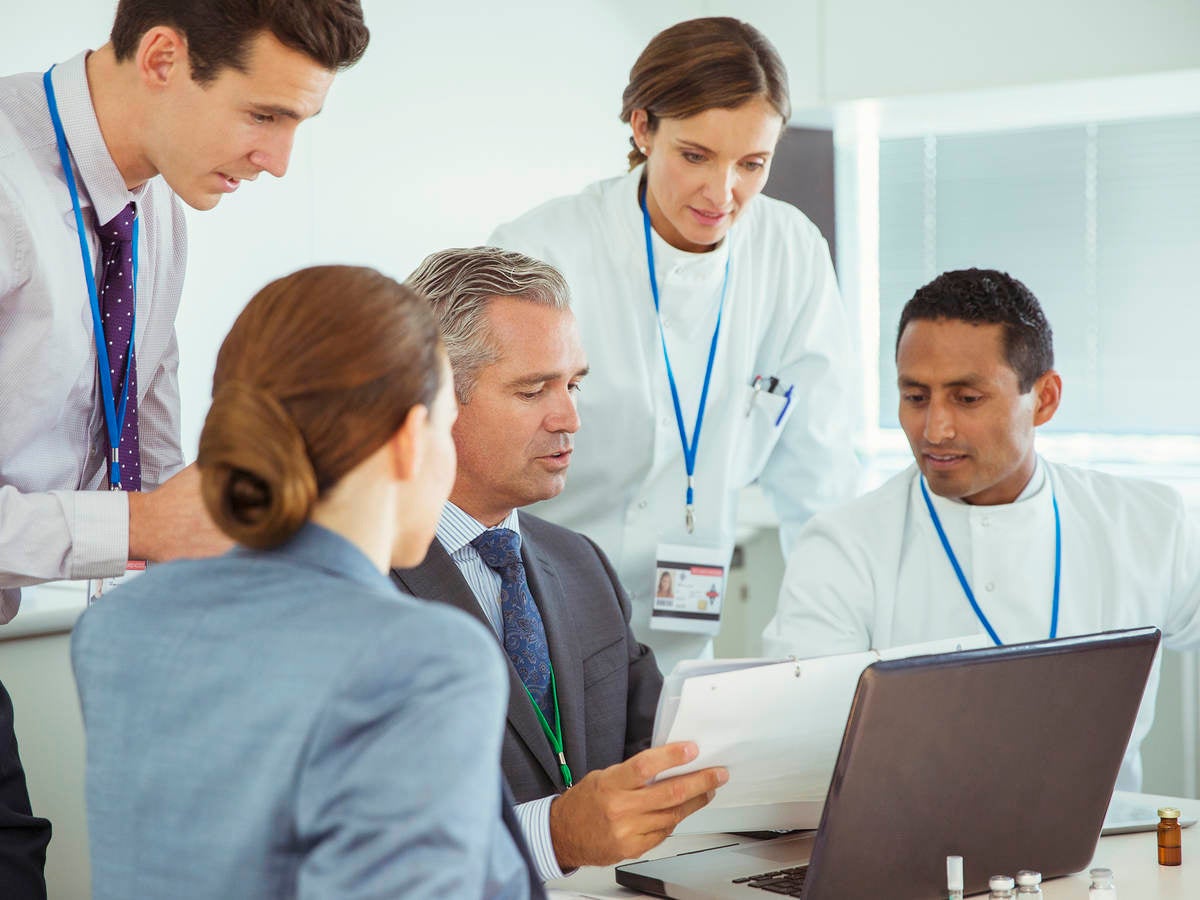 Scientists and business people talking in a conference room