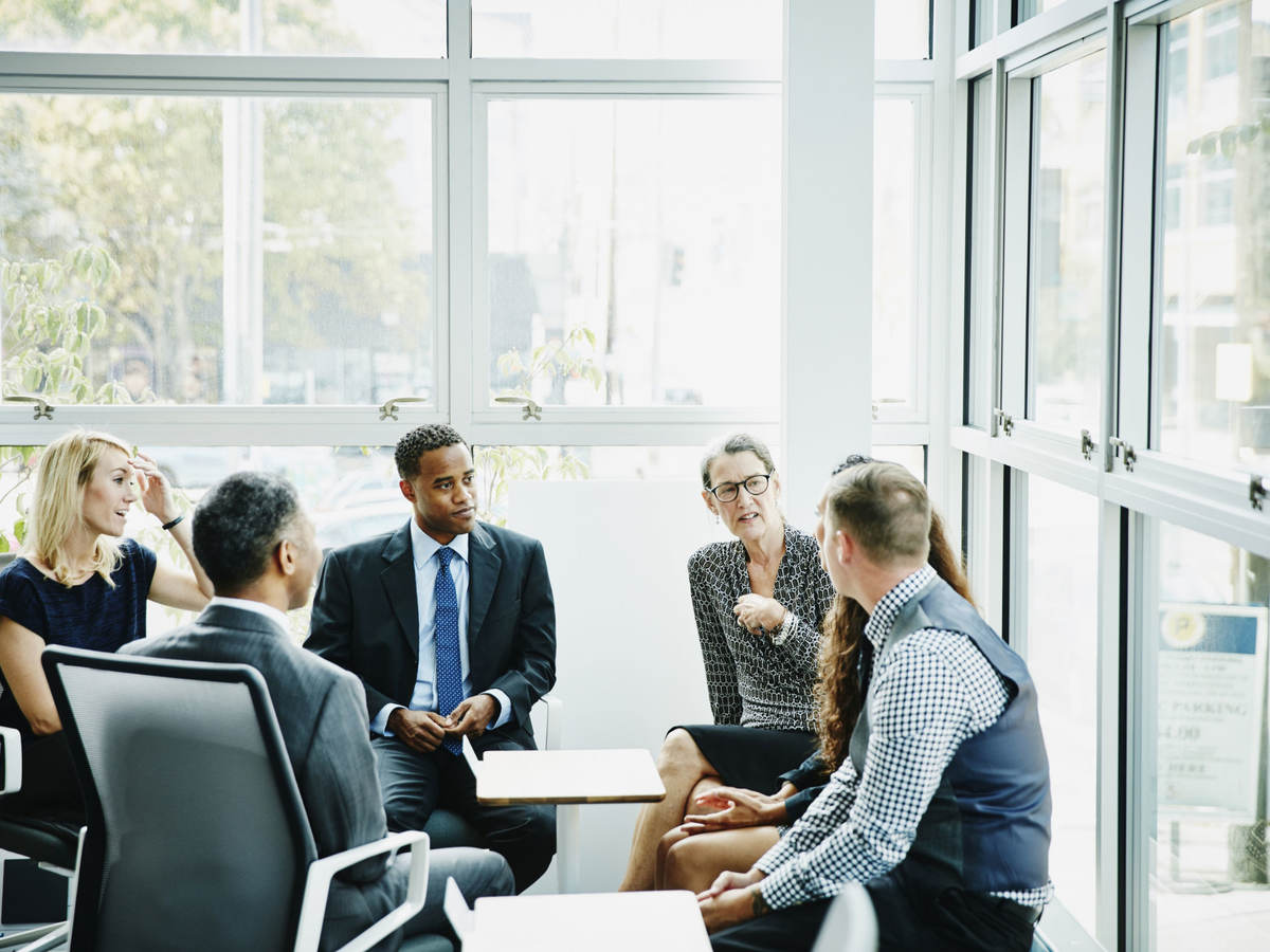 Group of business professionals having a discussion while sitting in a circle