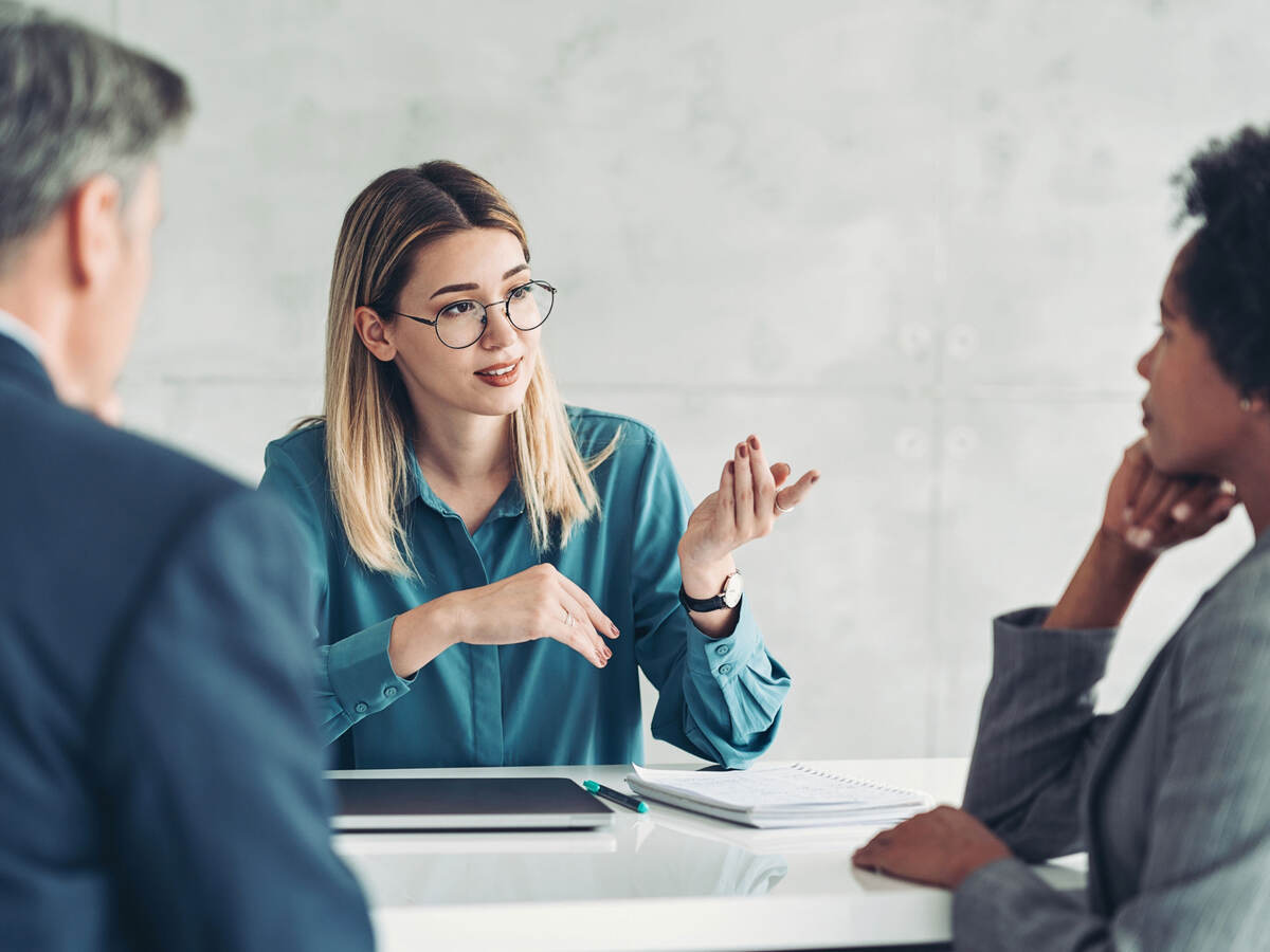 Three business professionals at a table having a meeting