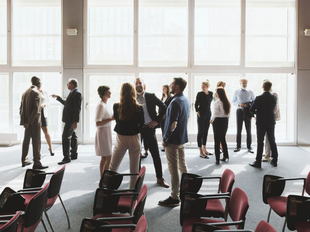 Group of business professionals greeting each other and shaking hands 