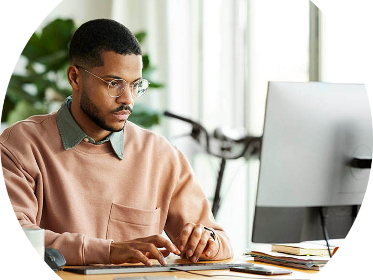 Person sitting at a desk taking an online webinar