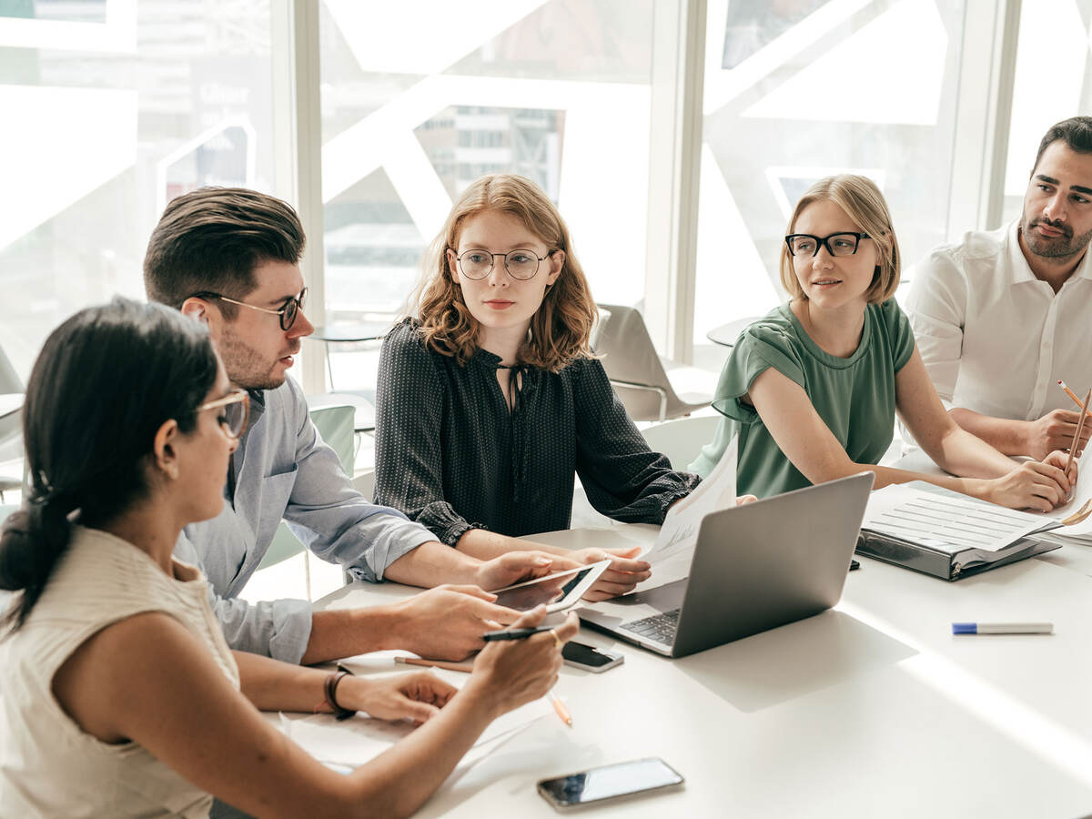Group of colleagues having a meeting in a contemporary office setting