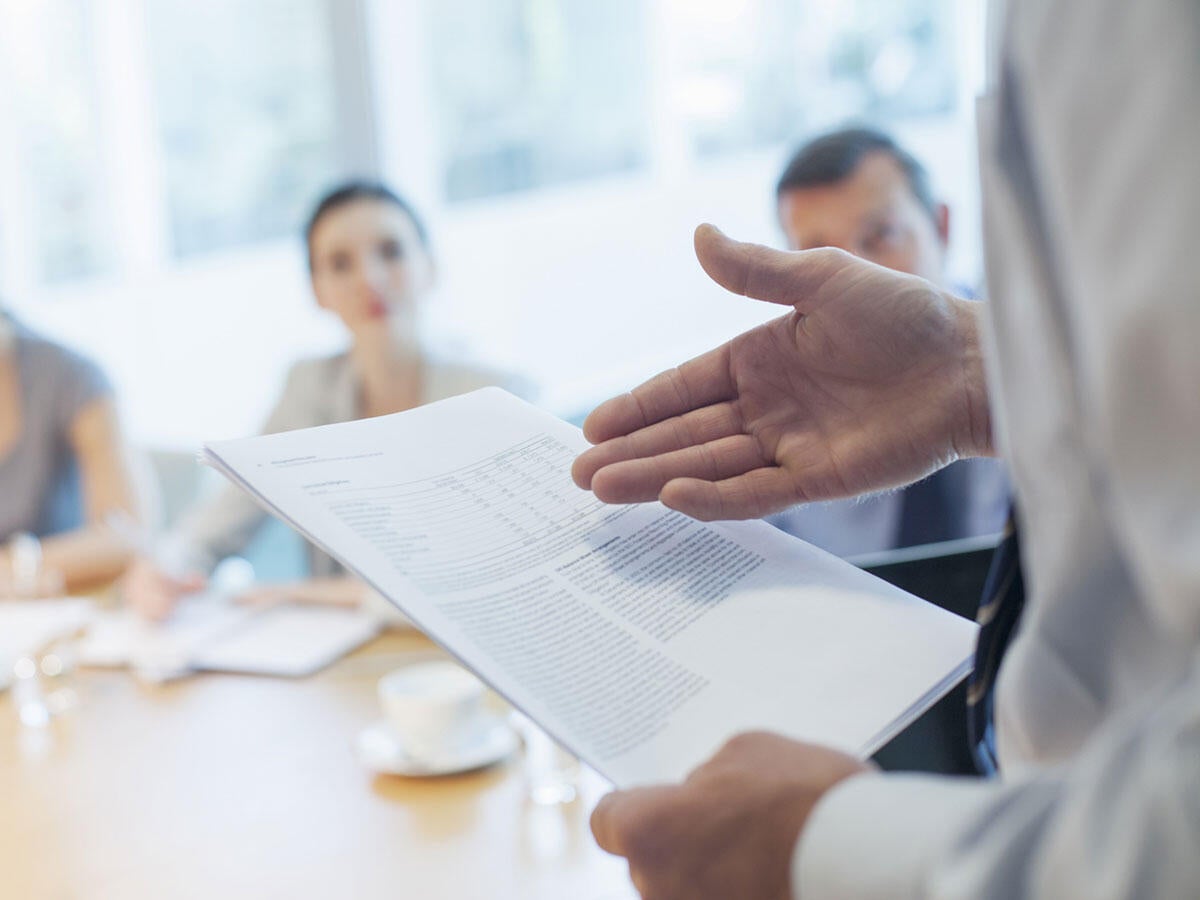 Lawyer presenting new legislation to a group of people in a meeting