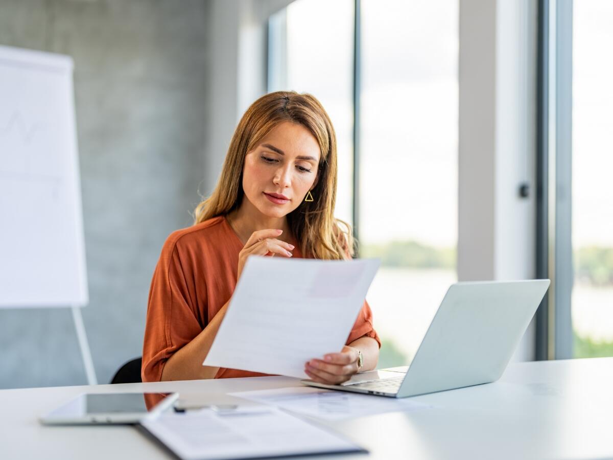 Person in a meeting room reviewing documents