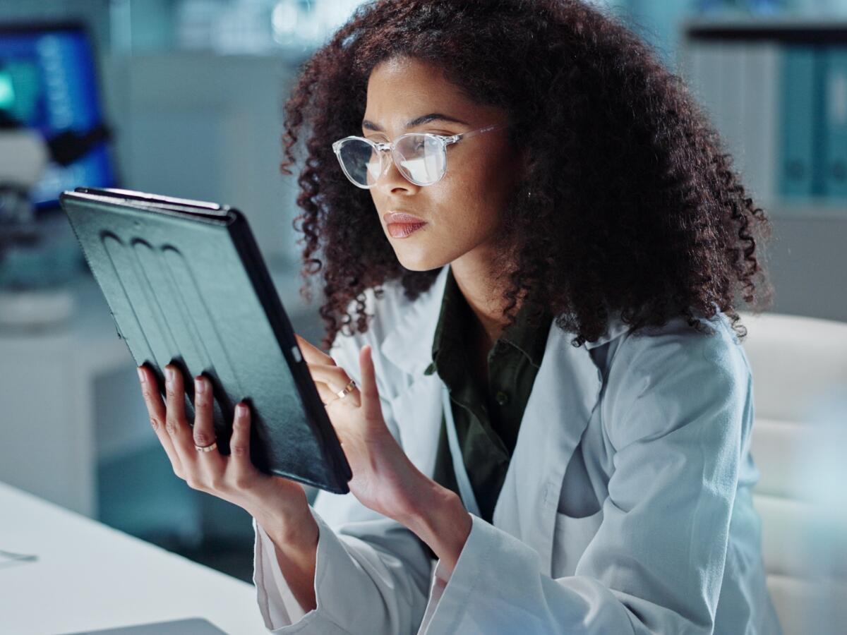 Medical professional reviewing results on a tablet