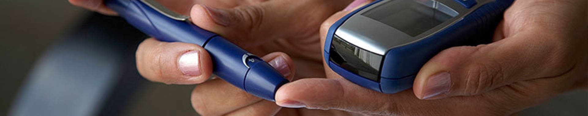 Person using a machine to check their blood sugar