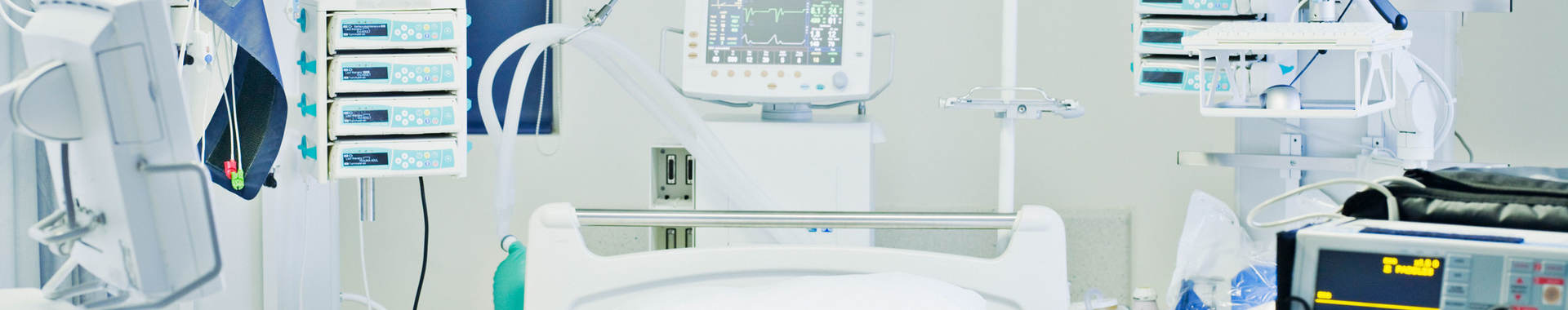 Medical equipment and monitors lined up in a hospital room
