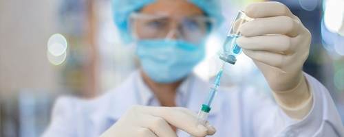 Nurse filling a syringe