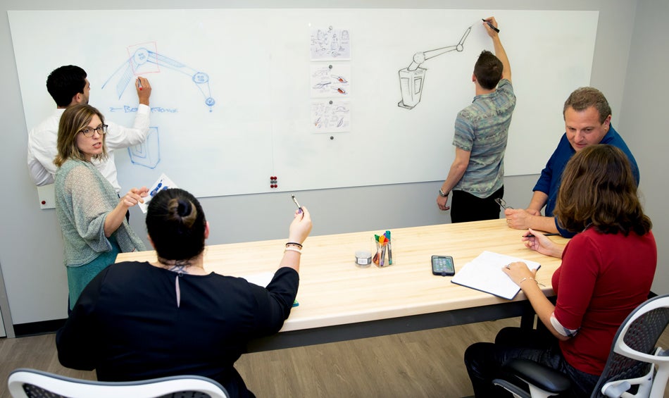 Drawing on a white board at a meeting