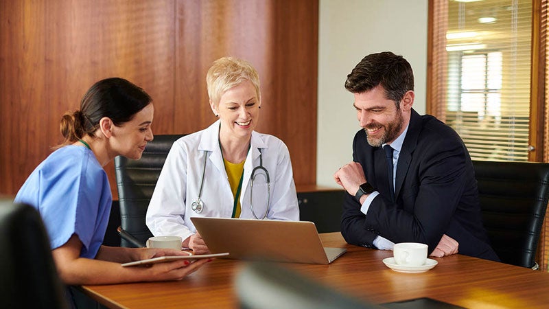 Three medical professionals meeting in a conference room