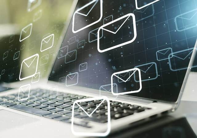 Laptop with email icons graphically overlaid