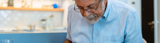Man reading covid test kit instructions