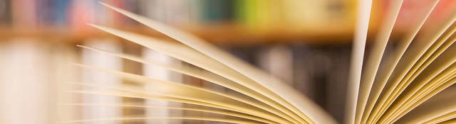 Book laying open on a table in a library