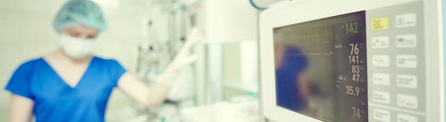 Surgery and intensive care unit. A doctor or nurse in surgical child neonatal hospital with artificial lung ventilation device