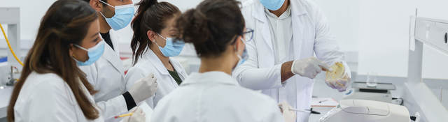 Group of lab technicians taking notes