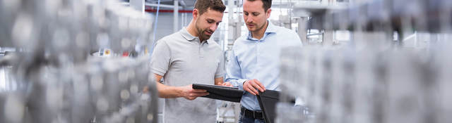 Two people comparing notes in a lab