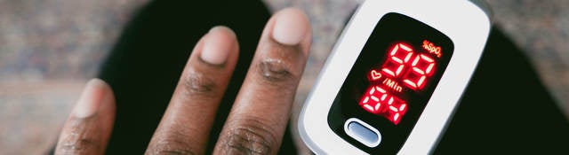 Person using Oximeter on finger