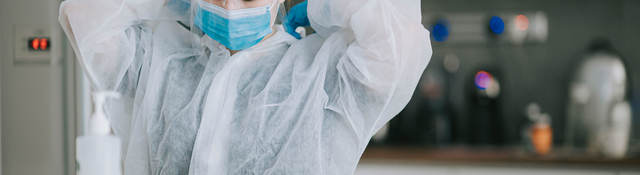 Scientist putting on PPE