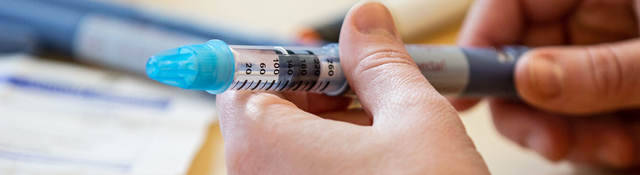 Person holding a syringe