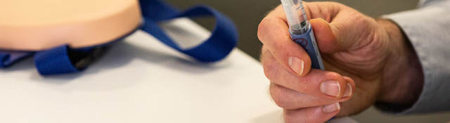 Person holding a syringe