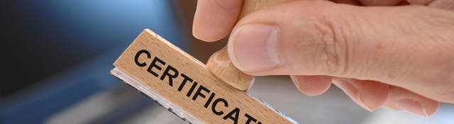 Person using a stamp with certification printed on it