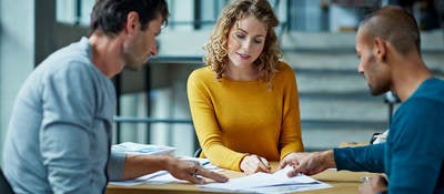 Three people at a table collaborating