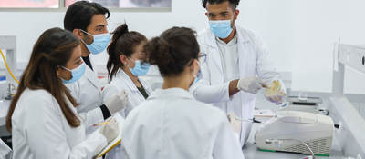 Group of lab technicians taking notes