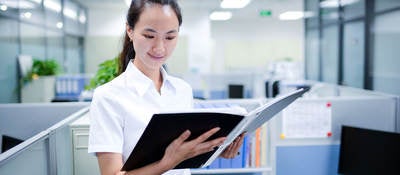 Person looking at documents in a binder